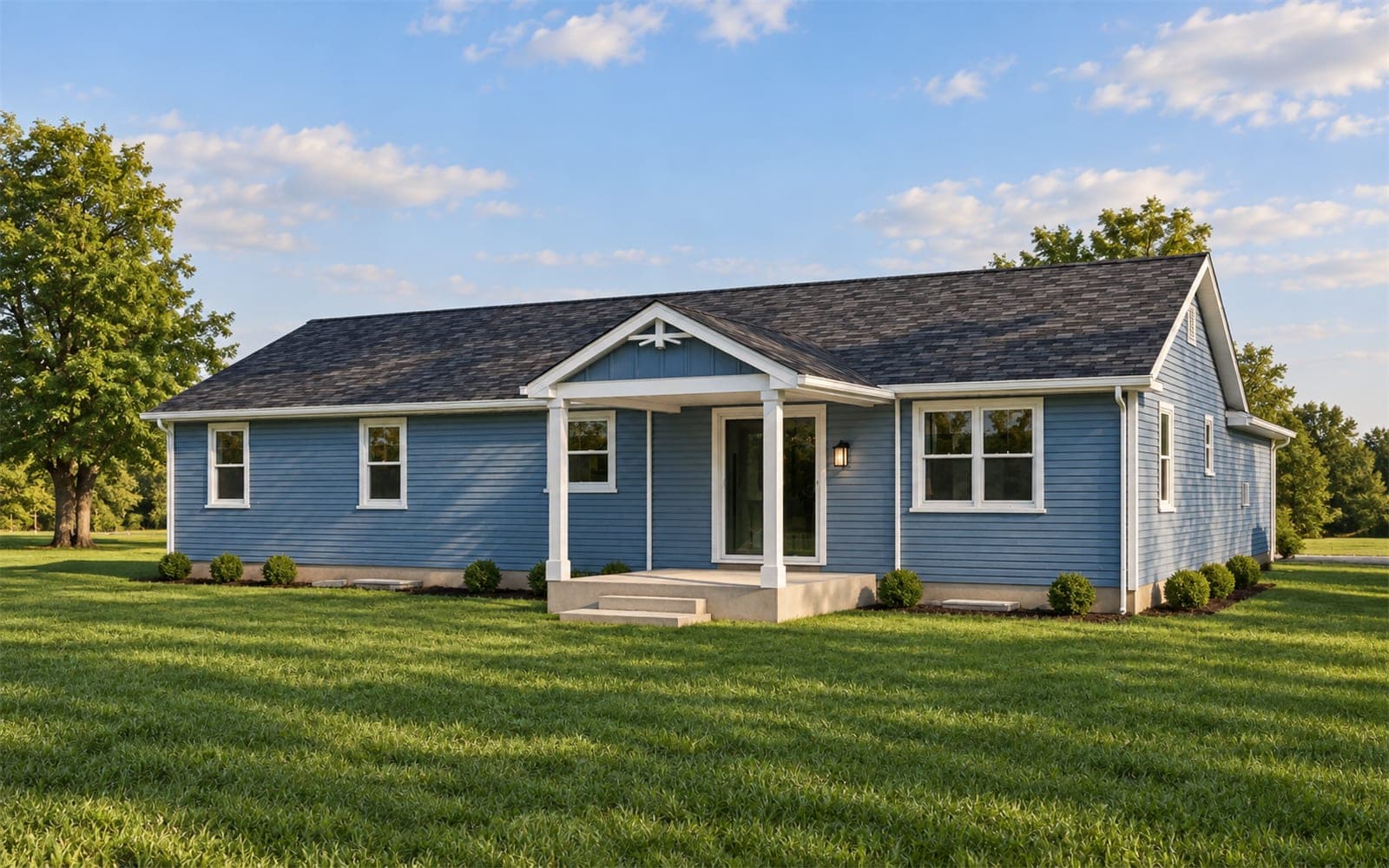 Back of a blue ranch home with a gabled covered rear porch, white posts and steps down to the lawn