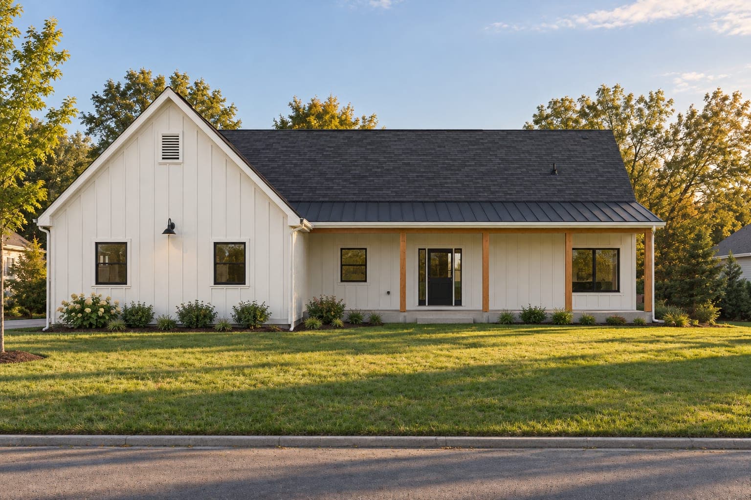 Front of a white board-and-batten modern farmhouse ranch with a metal-roofed front porch on cedar posts and black windows